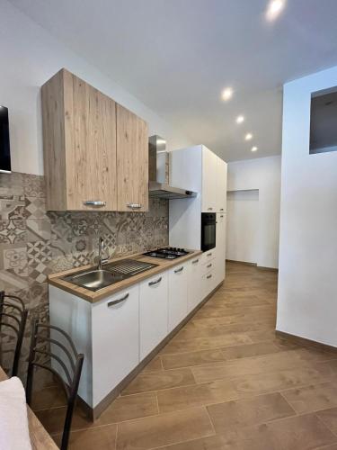 a kitchen with white cabinets and a sink at A casa di Alessandra in Milan