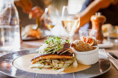 a plate with a sandwich and salad on a table at Hotell Åre Fjällsätra in Undersåker