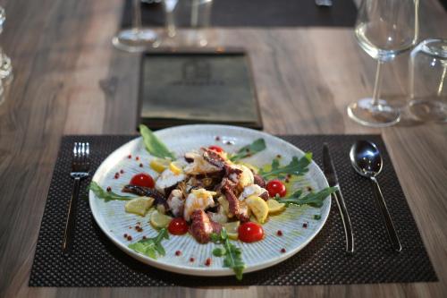 a plate of food on a table with a plate of food at Aliko Hotel in Vlorë