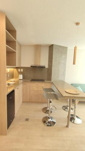 a large kitchen with a table and chairs in it at Onkel Inn Apart Suites in La Paz