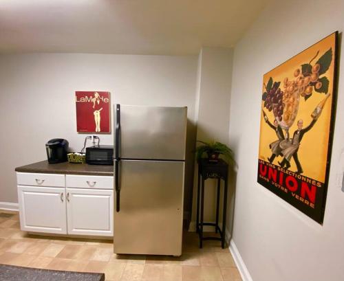 a kitchen with a stainless steel refrigerator and a counter at Charming Condo Near Downtown, NCSU and PNC Arena in Raleigh