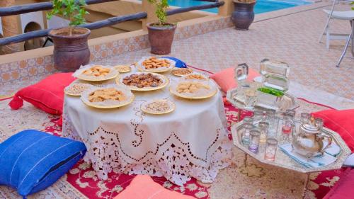 a table with plates of food on top of it at Riad Benyara in Taroudant