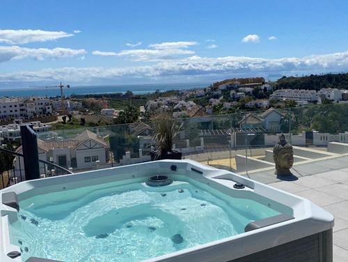 a hot tub on the balcony of a house at Oasis 325 New Luxury Penthouse with amazing sea view and private jacuzzi in Estepona