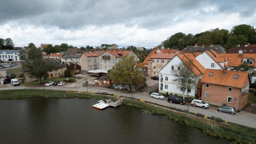 a small boat in a river in a town at Apartaments Nr.33 (Viesu Nr.3) in Talsi