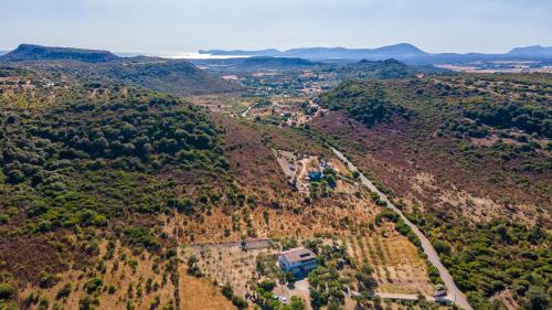an aerial view of a hill with a house on it at Lu Casal de Fiò in Alghero