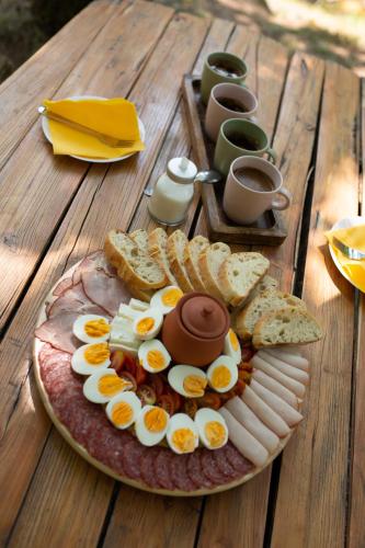a plate of eggs and bread on a wooden table at Brvnara Mila Vila in Pranjani