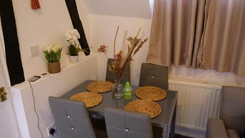 a dining room table with three plates on it at MK Shortstay Deluxe in Milton Keynes