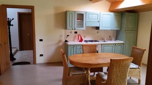 a kitchen with green cabinets and a wooden table at La Panoramica in Avenale