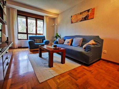 a living room with a couch and a coffee table at Apartamento Centro Gijón in Gijón