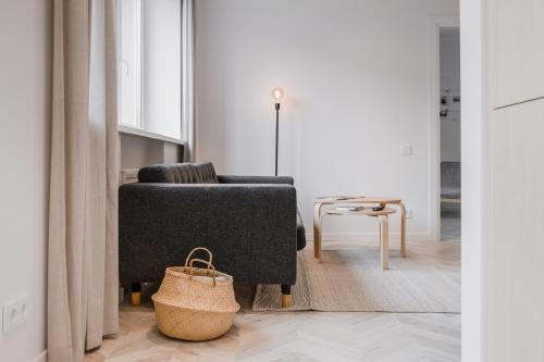 a living room with a couch and a chair at Central Apartment in Architectural Street in Kaunas