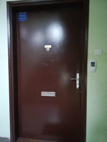 a brown elevator door with a sign on it at APARTMAN D&D*** in Varaždin
