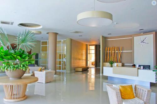 a lobby with chairs and a potted plant at Exclusive Apartasuites Reserva del Mar ツ in Gaira