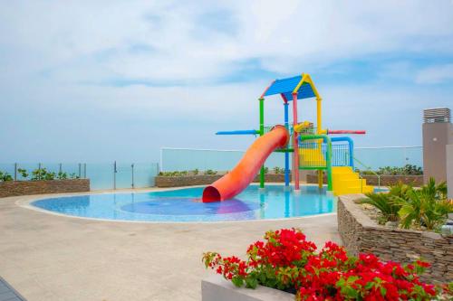a playground in a pool with a slide at Exclusive Apartasuites Reserva del Mar ツ in Gaira