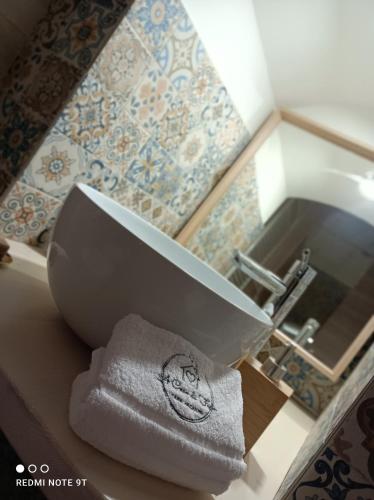 a bathroom with a sink and a towel on a counter at A Casa di Fede in Capurso