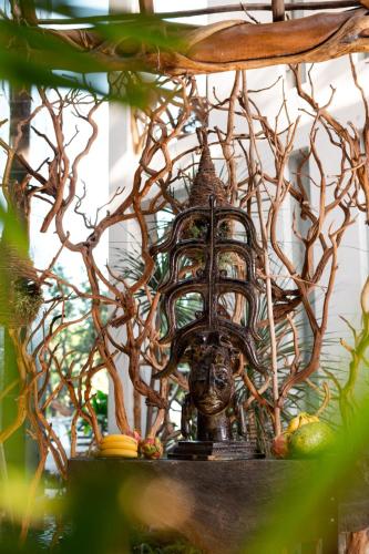 a statue of a head on a shelf with trees at Xkeban Tulum Adults Only in Tulum