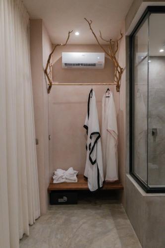 a bathroom with a walk in shower and a window at Xkeban Tulum Adults Only in Tulum