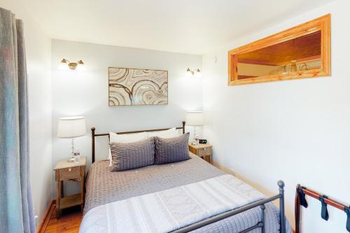 a bedroom with a bed with two night stands and two lamps at Grand Avenue Retreat in Bozeman