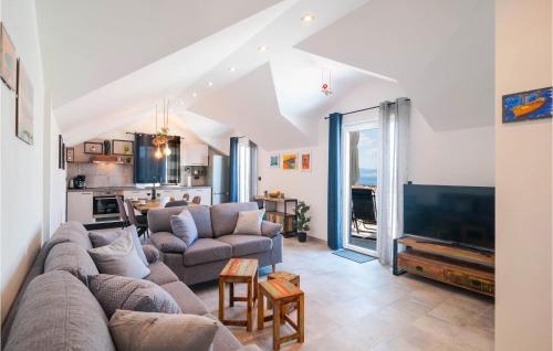 a living room with a couch and a tv at Amazing Apartment In Supetar With Wifi in Supetar