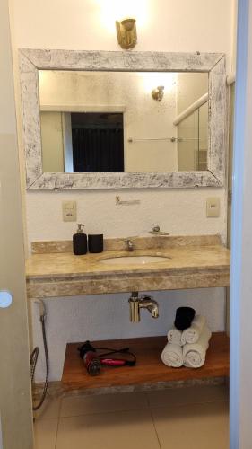 a bathroom with a sink and a mirror and towels at Top de Buzios Boutique Hotel & Spa in Búzios