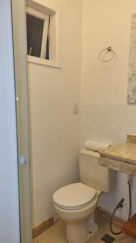 a bathroom with a white toilet and a sink at Top de Buzios Boutique Hotel & Spa in Búzios