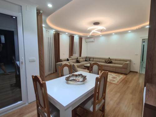 a living room with a table and a couch at Lida apartments in Ulcinj