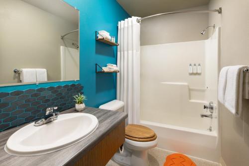 a bathroom with a sink and a toilet and a shower at The Ketch Inn in Ketchikan