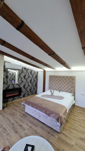 a bedroom with a large bed and a piano at Lux Star-vila za odmor in Bešenovački Prnjavor