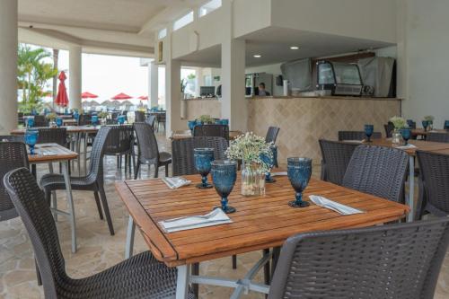 a dining room with a wooden table and chairs at Ocean Front Condo Sleeps 4 Adults-Grand Venetian T3000-1606 in Puerto Vallarta
