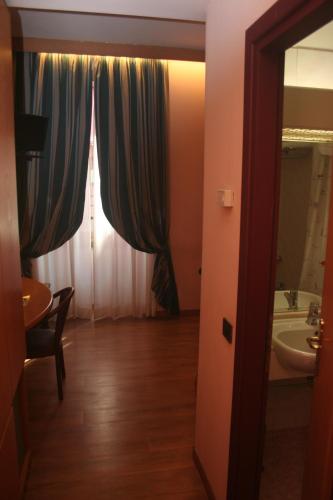 a bathroom with a sink and a mirror and a window at Albert Hotel in Milan