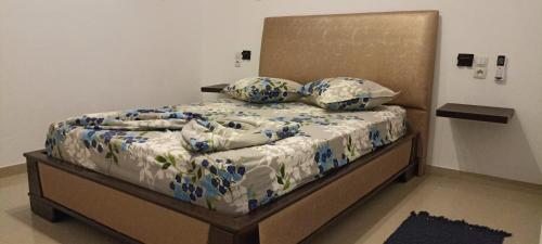 a bed with blue and white sheets and pillows at Dar Lebharr Kélibia in Kelibia