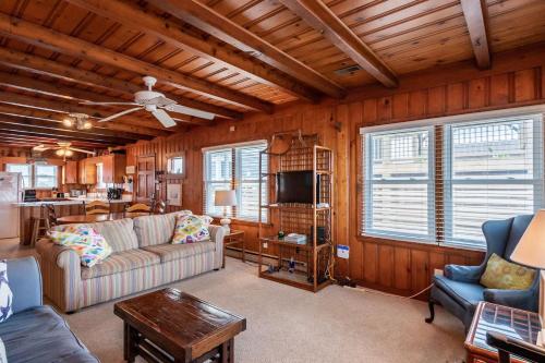 a living room with a couch and a table at Lowe Tide by Oak Island Accommodations in Oak Island