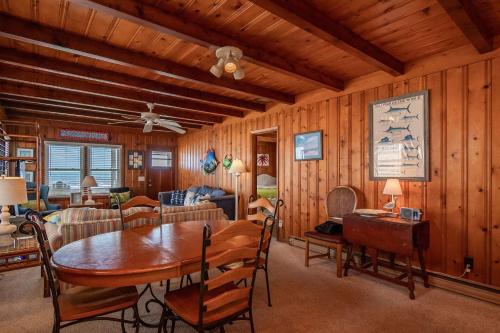 a dining room and living room with a table and chairs at Lowe Tide by Oak Island Accommodations in Oak Island