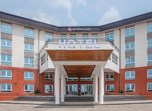 een hotelgebouw met een hotelbord aan de voorzijde bij Best Western Plus Soaho Douala Airport in Douala