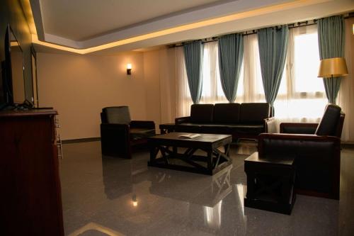 a living room with a couch and chairs and a table at Best Western Plus Soaho Douala Airport in Douala