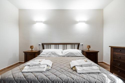 a bedroom with a bed with towels on it at Podere Mezzastrada - Place of Charme in Fiano