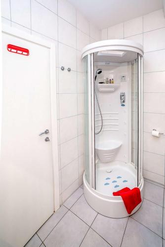 a bathroom with a shower with a toilet in it at Art Deco Zagreb centre view in Zagreb