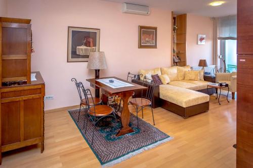 a living room with a couch and a table at Art Deco Zagreb centre view in Zagreb