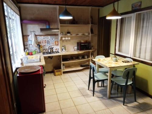 a kitchen with a table and chairs in a room at Departamento La Solar in Frutillar