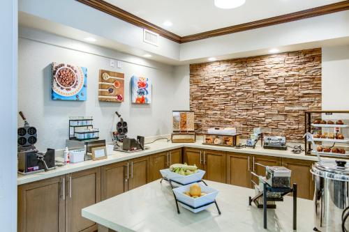 a restaurant with a counter and a brick wall at Staybridge Suites Gulf Shores by IHG in Gulf Shores