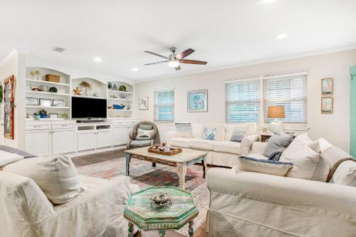 a living room with white furniture and a ceiling fan at 96097 Piney Island in Fernandina Beach