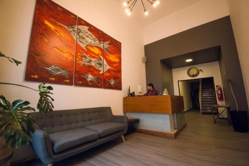 a woman at a reception desk in a waiting room at Chill Inn Hostel in Mendoza