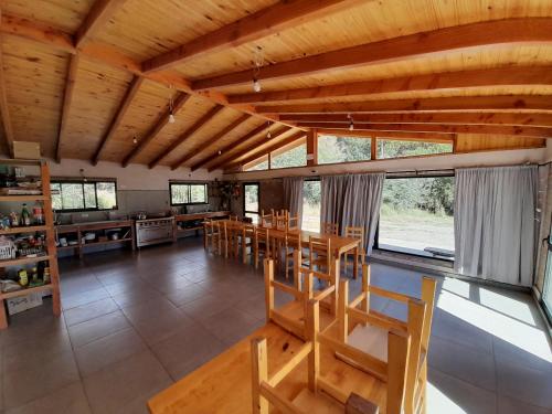 a large room with a table and a kitchen at PUERTO HOSTEL in El Hoyo