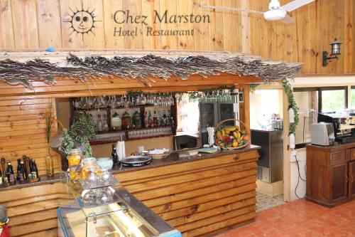a bar in a restaurant with a counter at Chez Marston in La Digue