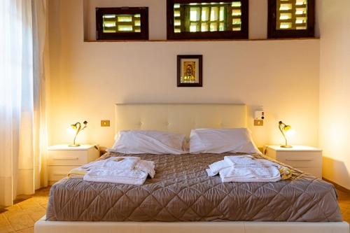 a bedroom with a bed with two towels on it at Podere Mezzastrada - Place of Charme in Fiano