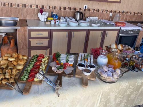 a table with many different types of food in a kitchen at Guest House Vera in Ulcinj