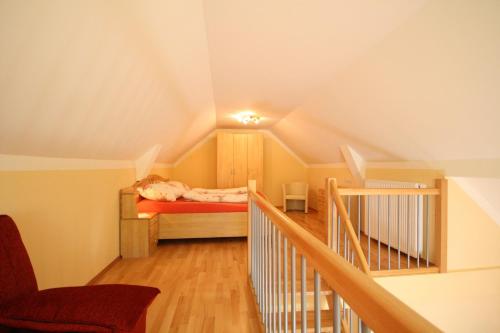 a attic room with a bed and a staircase at Pichlhof Apartments - Comfort Near Planai in Schladming