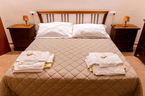 a bedroom with a bed with two towels on it at Podere Mezzastrada - Place of Charme in Fiano