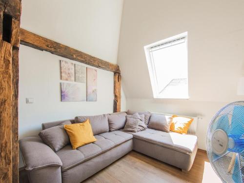 a living room with a couch and a window at Ferienwohnung in Herbolzheim in Herbolzheim