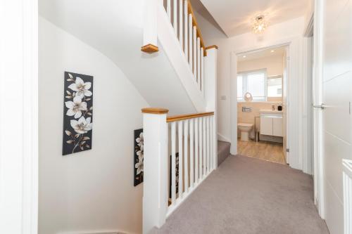 a staircase in a home with white walls at Greenfield Holiday Homes in Bracknell