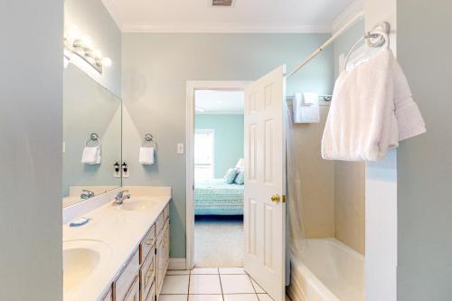 a bathroom with a sink and a shower and a tub at Sunny Side Up in Dauphin Island